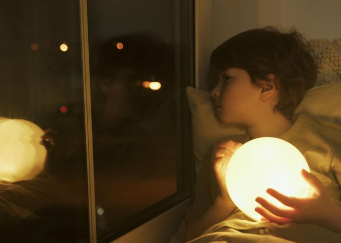 Person smiling peacefully after a light workout session at home.