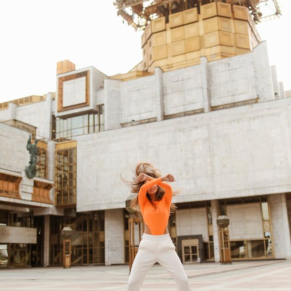 Woman feeling energetic and balanced in a bright, open space.